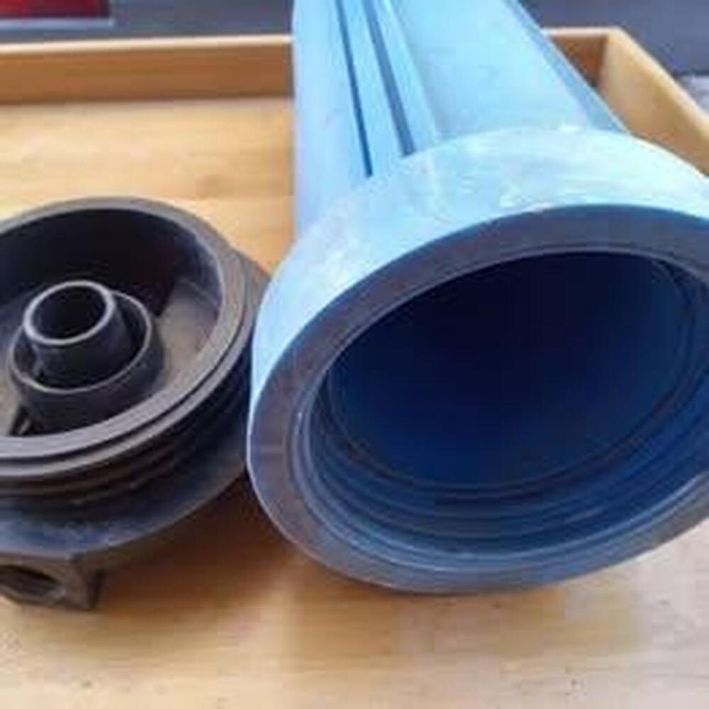 Blue whole house water filter housing, with black cap.